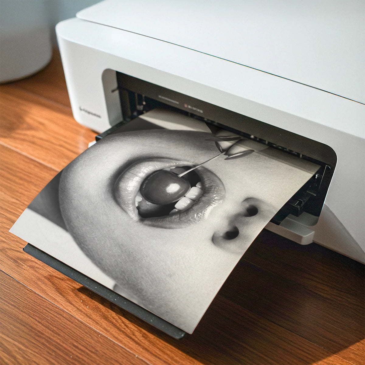 An at home printer printing digital download poster print cherry bomb depicting a woman holding a cherry between her teeth