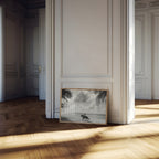 Framed coastal cowgirl artwork on a wall in a room with wooden flooring and white walls.
