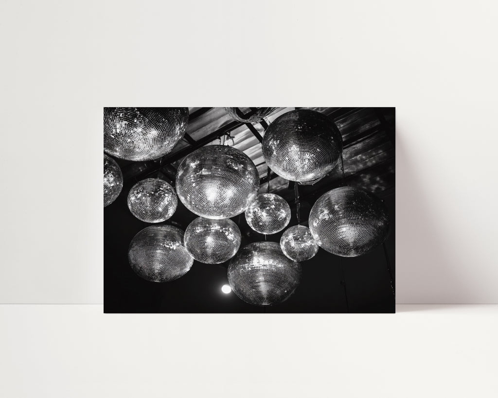 Black and white poster print of disco balls on a ceiling
