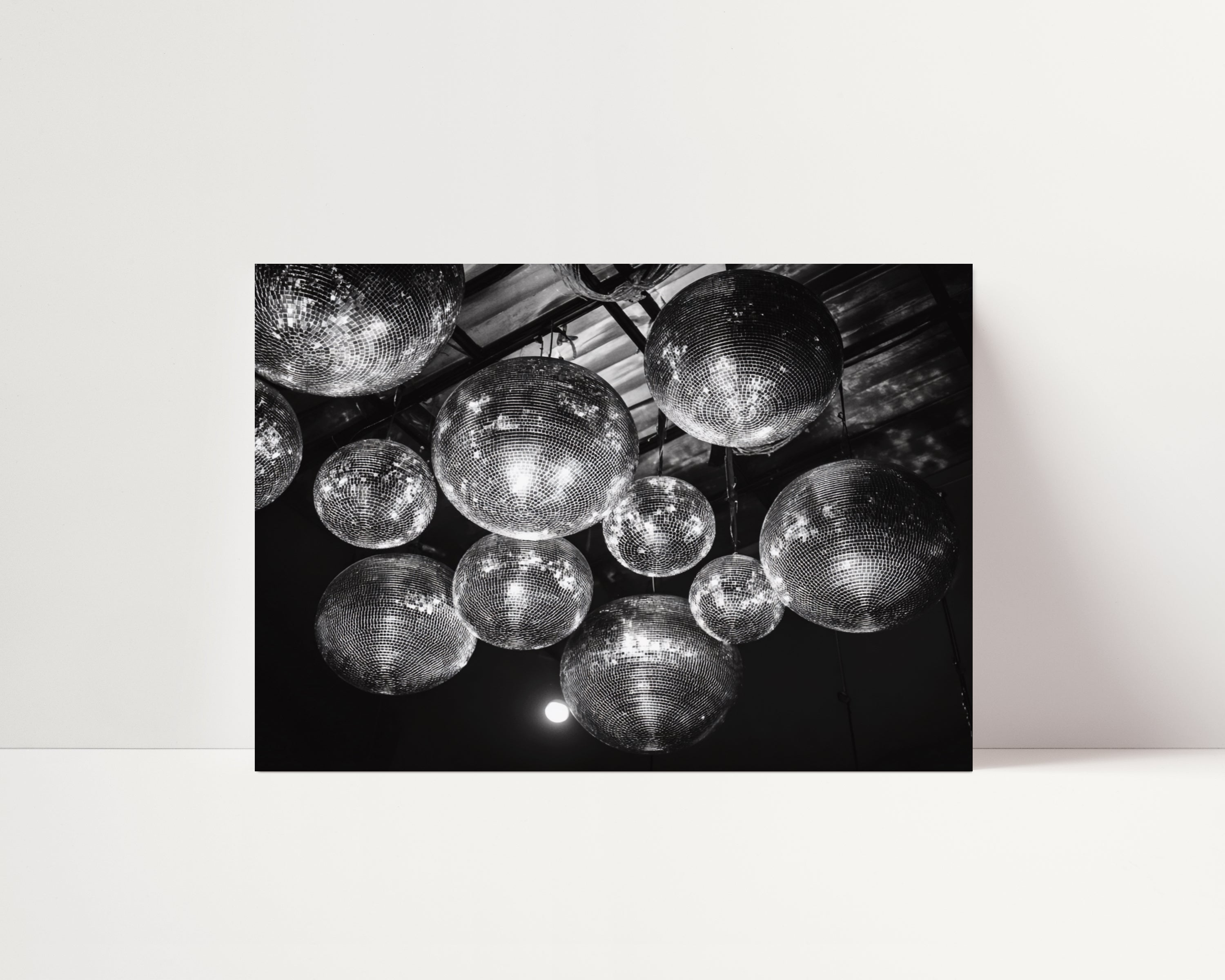 Black and white poster print of disco balls on a ceiling