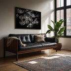 monochromatic disco party poster print frame hanging in Living room above black leather sofa, decorative pillows, and a large window.