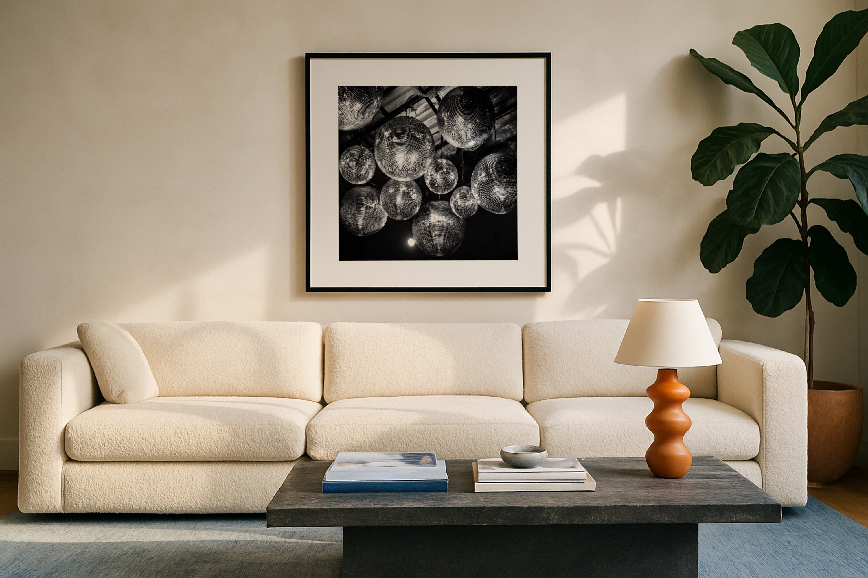 disco party black and white wall art print hanging in Modern living room over a beige sofa, coffee table, and decorative items.