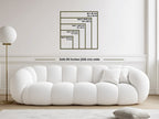White sofa with dimensions displayed on a wall in a minimalistic room.