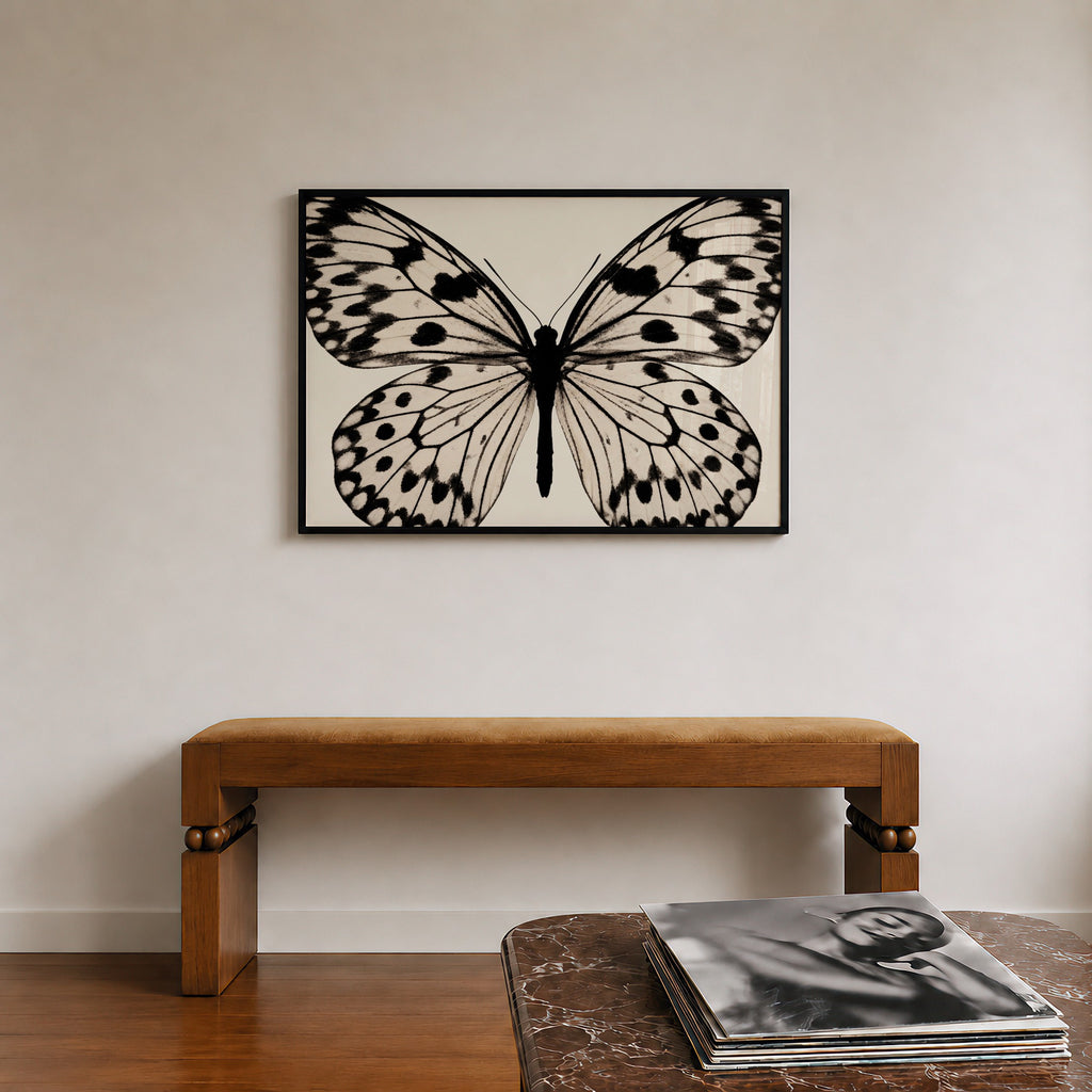 framed black and white poster print hanging over bench in entryway with records sitting on the counter across