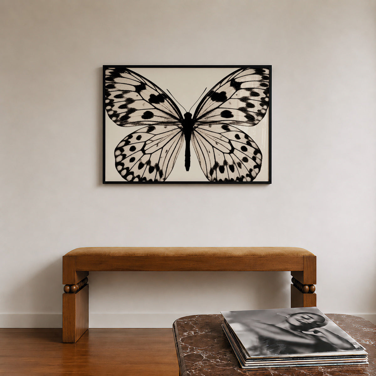 framed black and white poster print hanging over bench in entryway with records sitting on the counter across