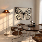 framed black and white butterfly poster print hanging above table in dining room with Chetah accents.