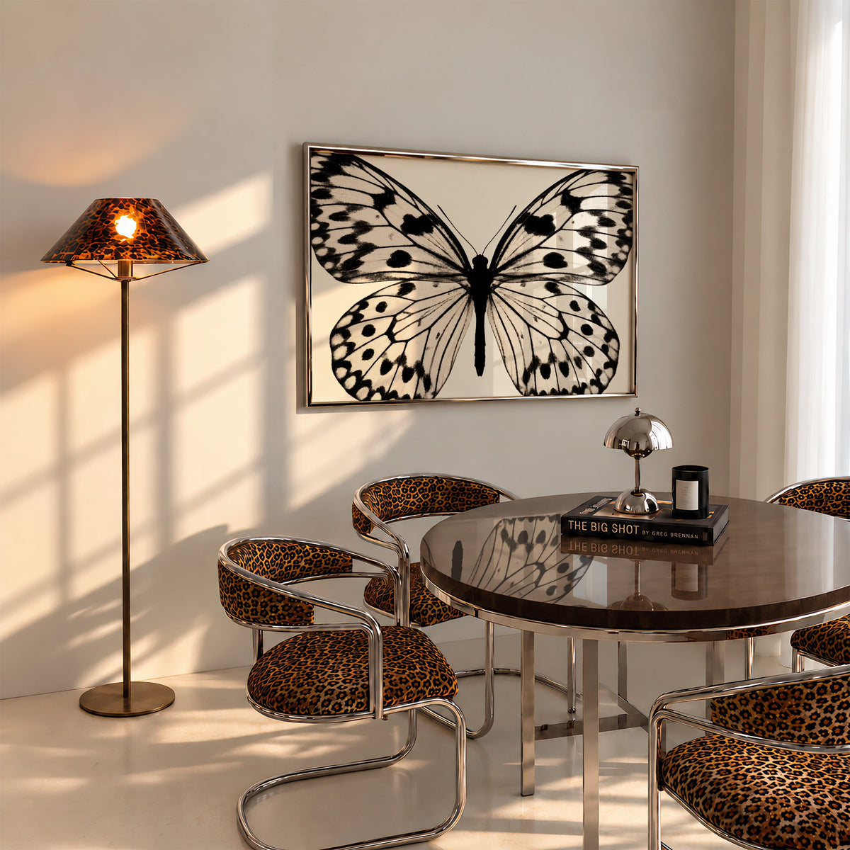 framed black and white butterfly poster print hanging above table in dining room with Chetah accents.