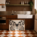 framed butterfly poster print leaning against cabinets in a modern kitchen with wooden panels and modern finishes