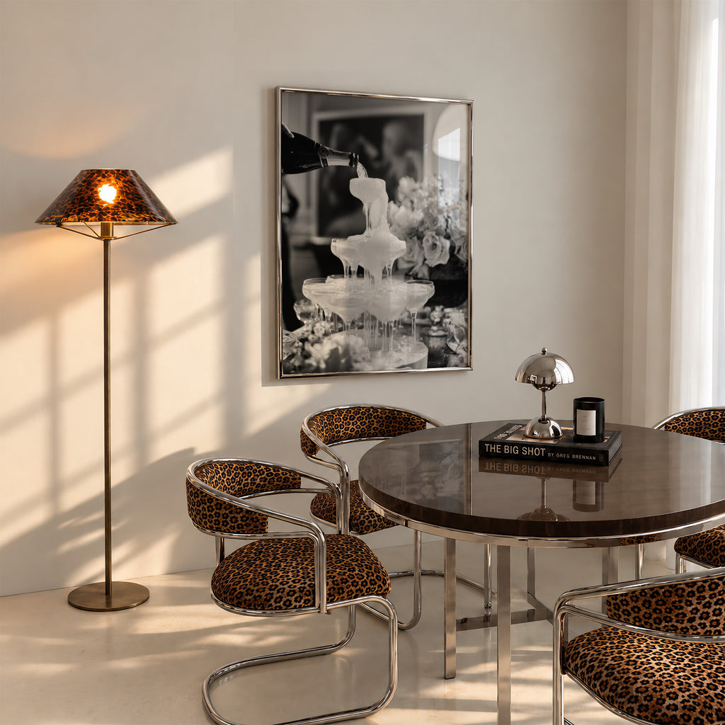 framed champagne showers poster print hanging above table in dining room with cheetah accents