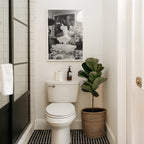 framed black and white champagne shower poster print above toilet bathroom glam room decor