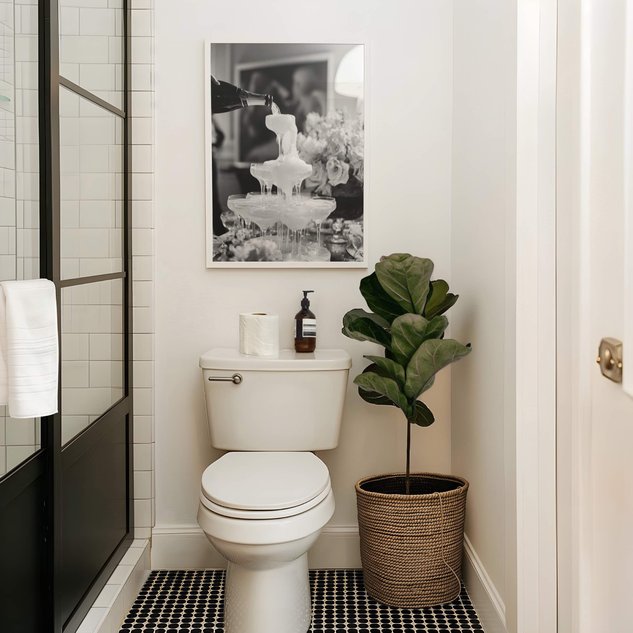 framed black and white champagne shower poster print above toilet bathroom glam room decor