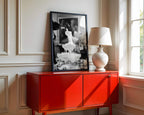 framed black and white champagne showers poster print sitting on red cabinet leaning against wall glam entryway wall art