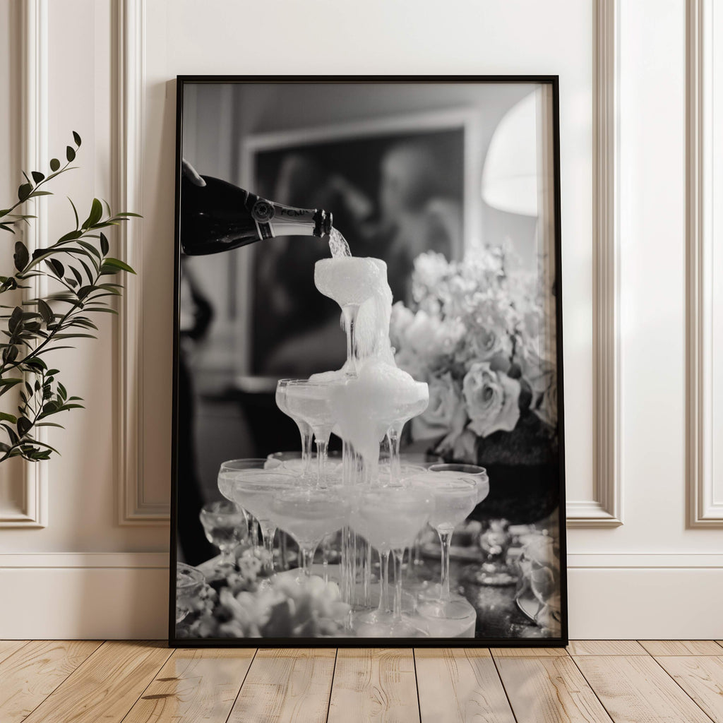 framed black and white champagne showers wall art print leaning against wall