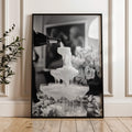 framed black and white champagne showers wall art print leaning against wall