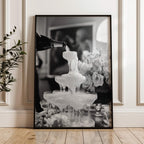 framed black and white champagne showers wall art print leaning against wall