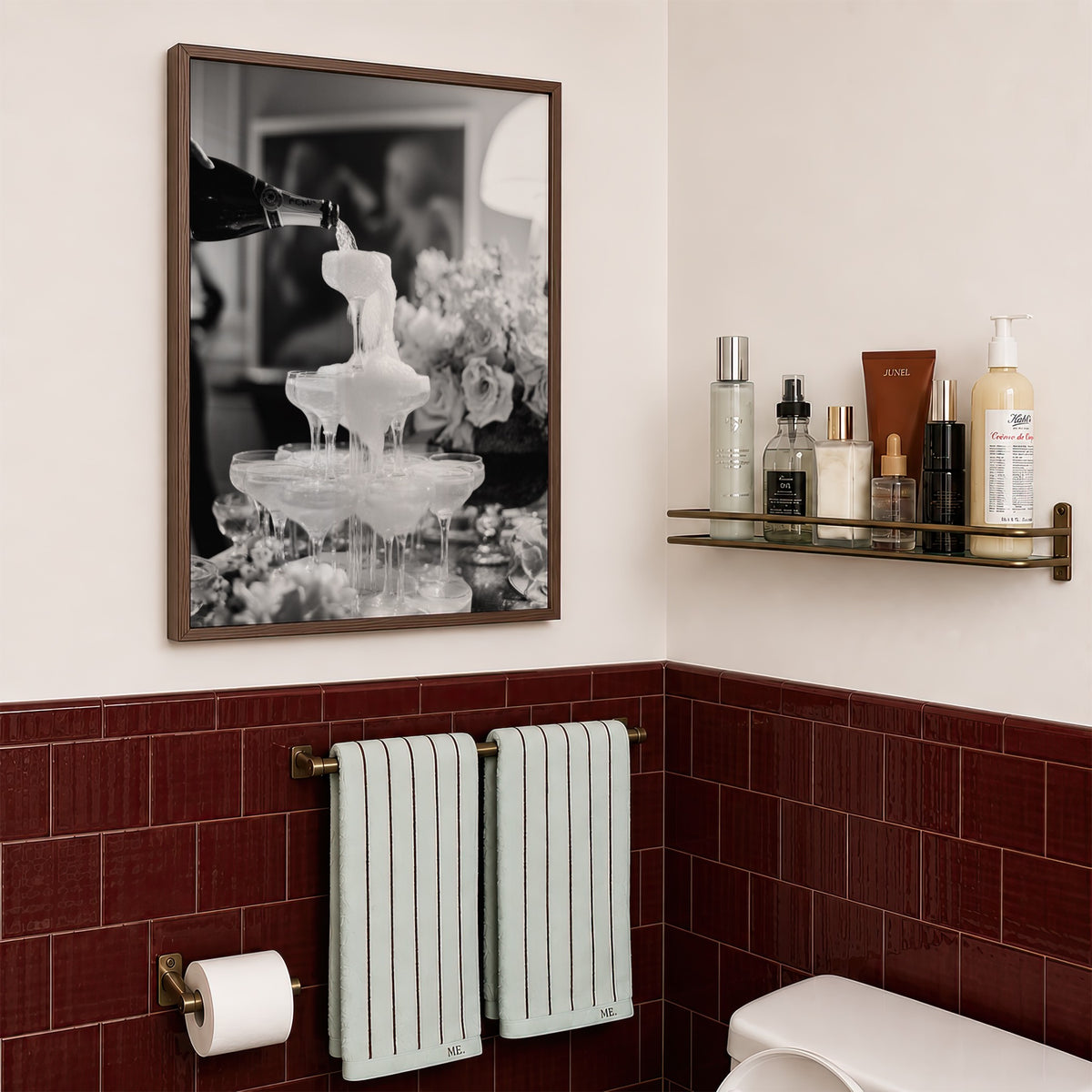 framed black and white champagne showers poster print hanging in bathroom with red tiles