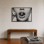 framed black and white poster print of cherry bomb, cherry between woman's lips framed hanging above console in entry way