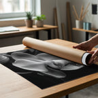 black and white floral poster being unrolled from poster tube
