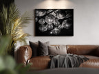 black and white framed wall art  hanging in Brown leather sofa with decorative pillows and a plant in a living room setting.