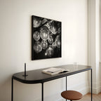 Modern interior with a black console table, stool, and black and white poster print art on a white wall.