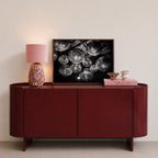 framed black and white disco ball poster print on red console with pink decor in entryway