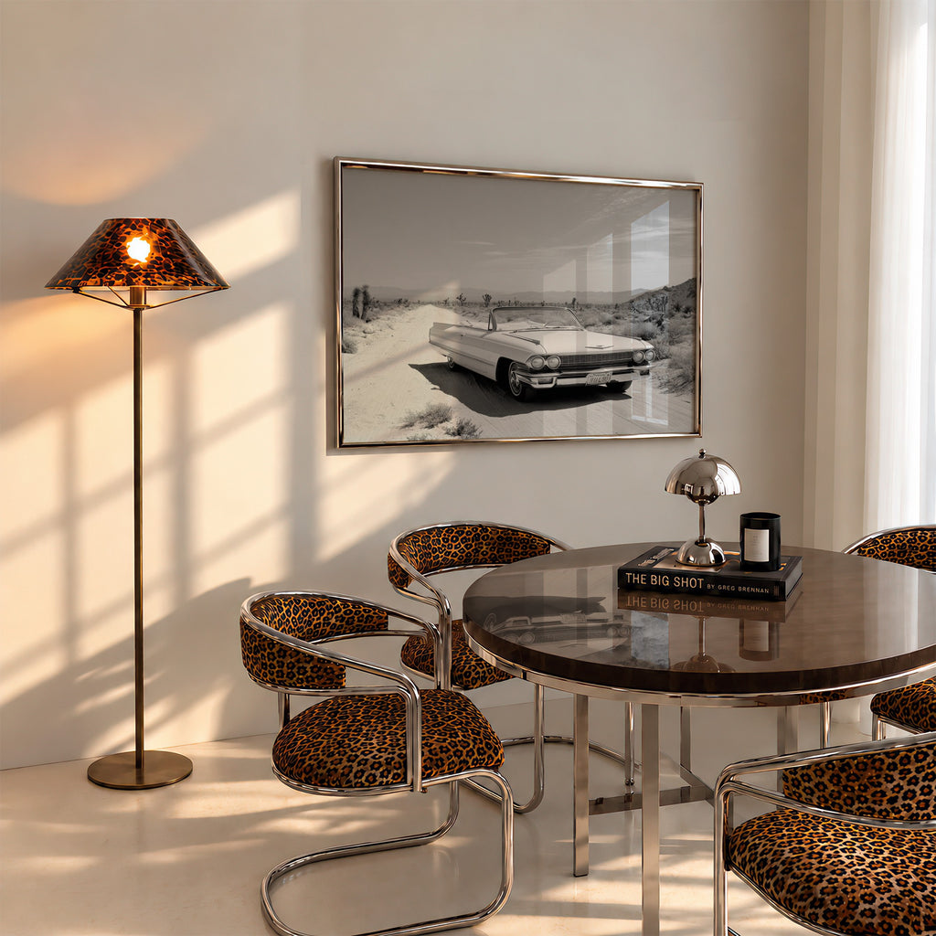 framed black and white Dust & Dreams poster print wall art hanging above kitchen table in dining room with cheetah accents