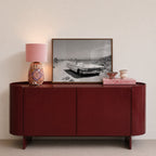 framed black and white Dust & Dreams poster print wall art sitting on red console with pink decor