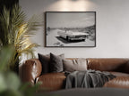 Brown leather sofa with cushions and a blanket in a living room setting, featuring a Framed black and white dust and dreams wall art  hanging on the wall