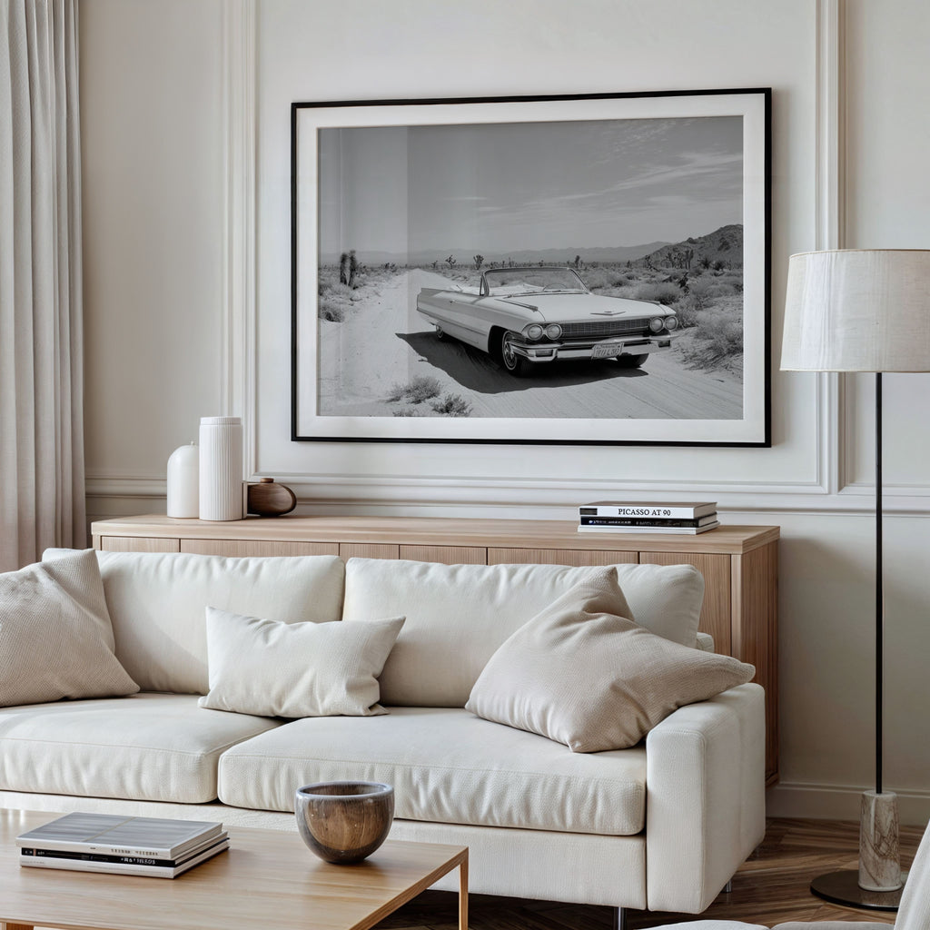 Framed black and white dust and dreams wall art  hanging above white couch in modern living room