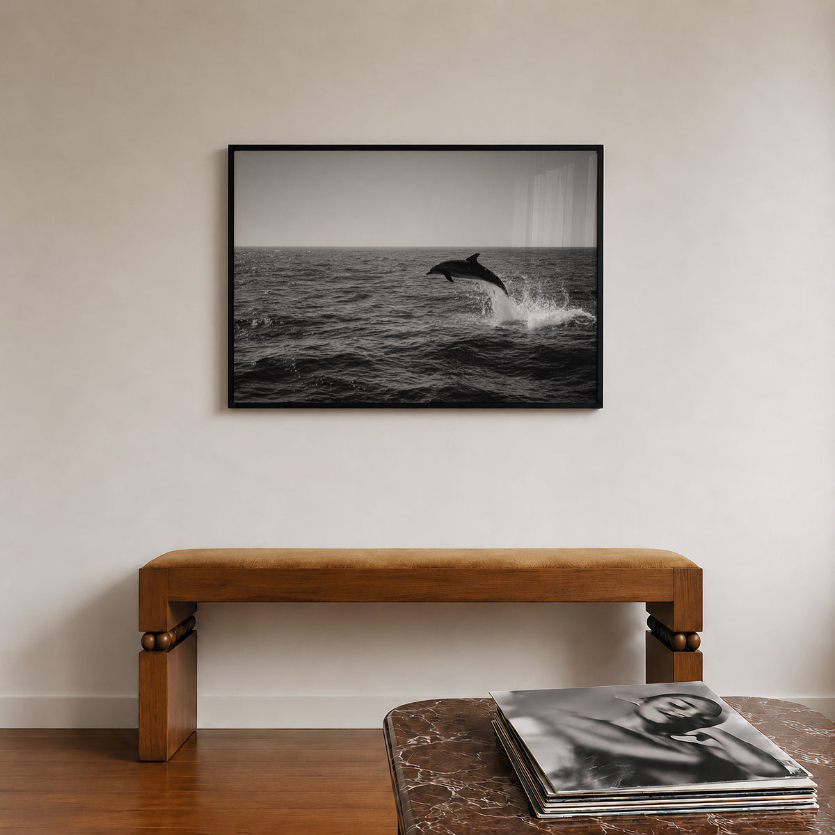 framed black and white dolphin poster print hanging in entryway above bench