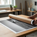 hands unrolling black and white cool poster print from poster tube