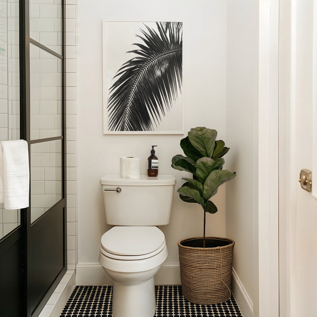 black and white paradise palm wall art hanging above toilet in bathroom