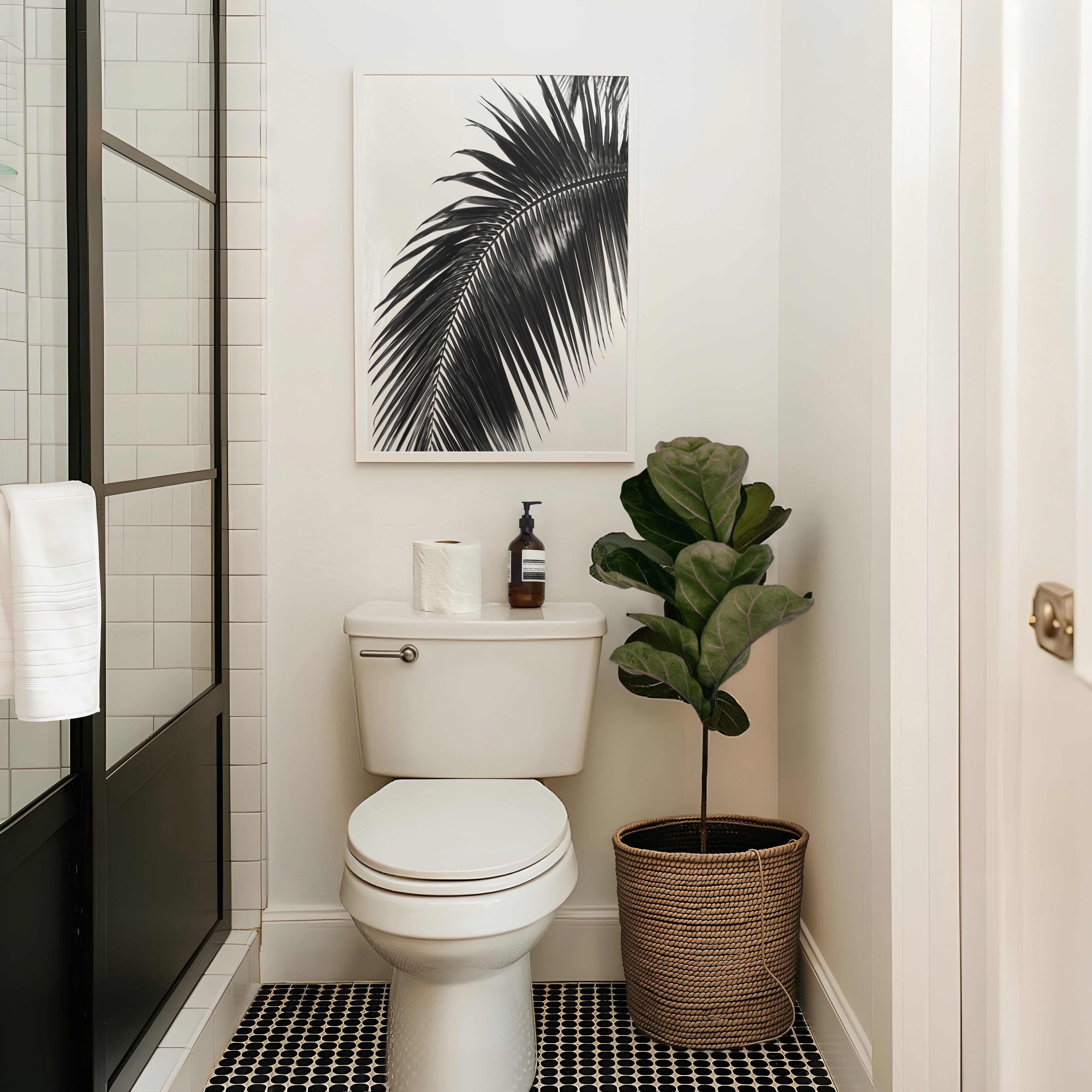 black and white paradise palm wall art hanging above toilet in bathroom