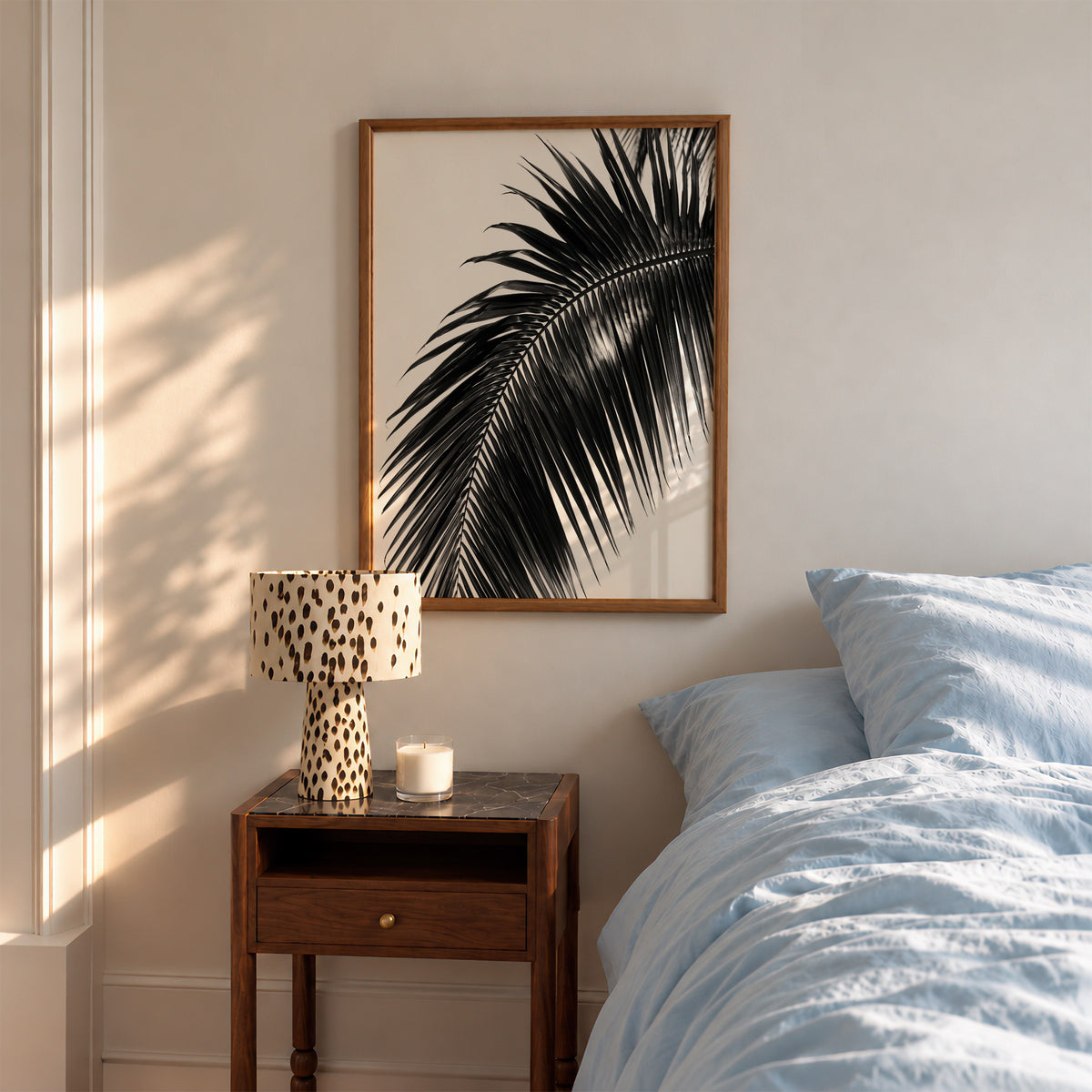 framed paradise palm poster print hanging in bedroom above nightstand