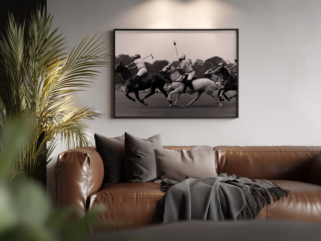 Living room with brown leather sofa, decorative pillows, and a framed black and white polo club poster print above couch decor