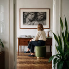 black and white marble statue wall art hanging as office decor above desk while a woman looks on
