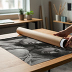 set in stone black and white roman statue poster print being unrolled from packaging