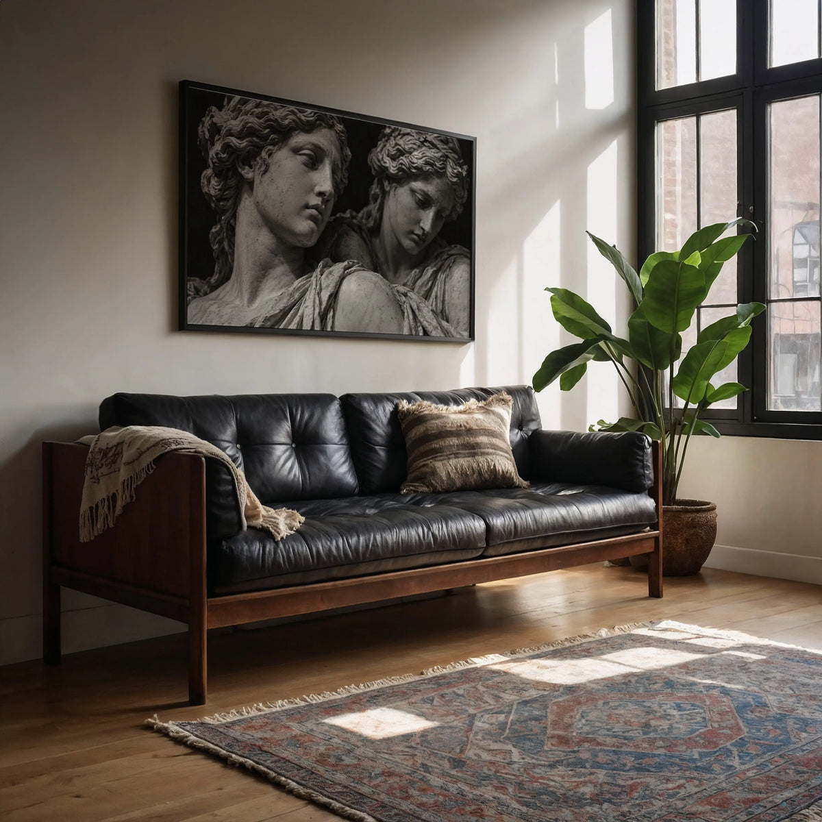 black and white marble statue poster print hanging above black leather couch in living room