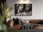 black and white set in stone marble stature wall art poster pring hanging in living room above brown leather couch