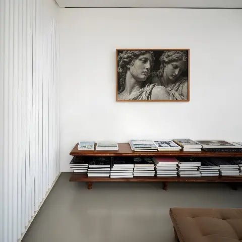 black and white set in stone wall art poster pring hanging above cradenza with magazines in the entryway